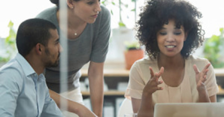group of people with a laptop talking at a meeting.