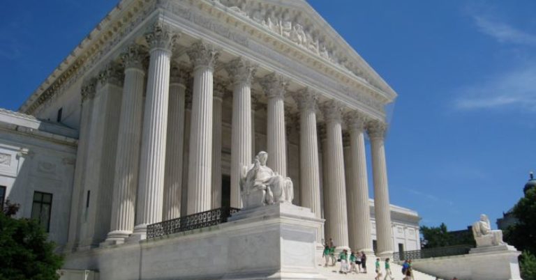 surpreme court with people walking up the steps