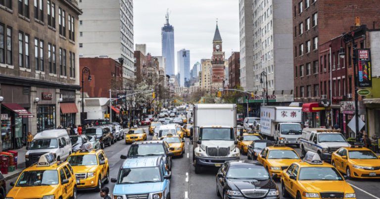 cars and taxis driving in new york city transportation