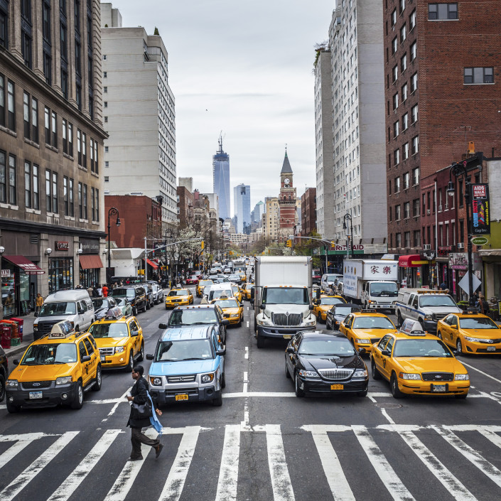 cars and taxis driving in new york city transportation