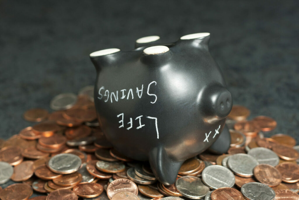 a piggy bank poured out that has "life savings" written on it