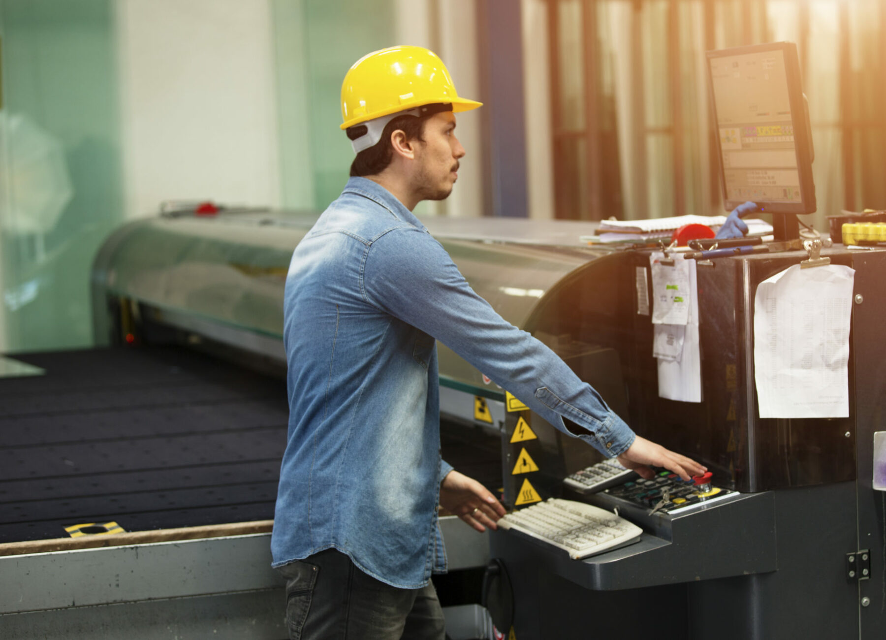 Hardhat worker operating a machine