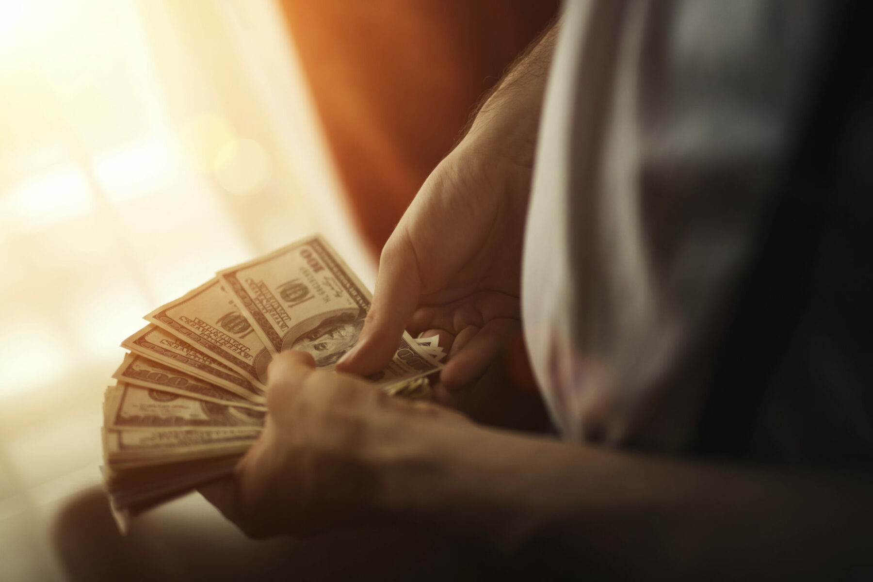 close up shot of a man's hands holding money