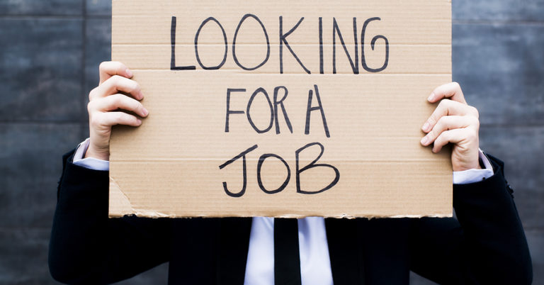 Young businessman holding sign looking for a job