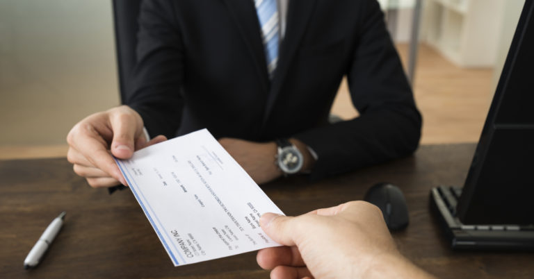 Businessman Giving Cheque To Other Person