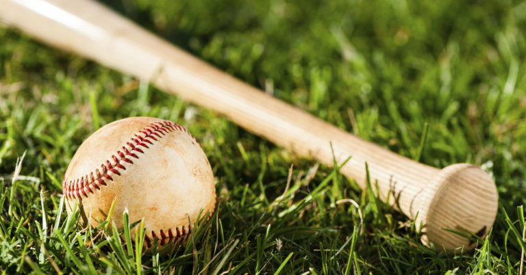 Baseball Bat and Ball on Grass Field