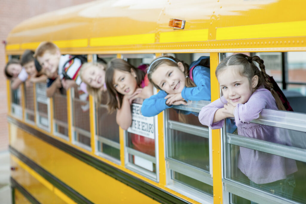 Children Sticking Their Heads Out of the School Bus