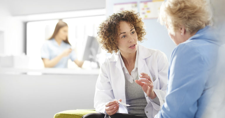 nurse talks to old woman