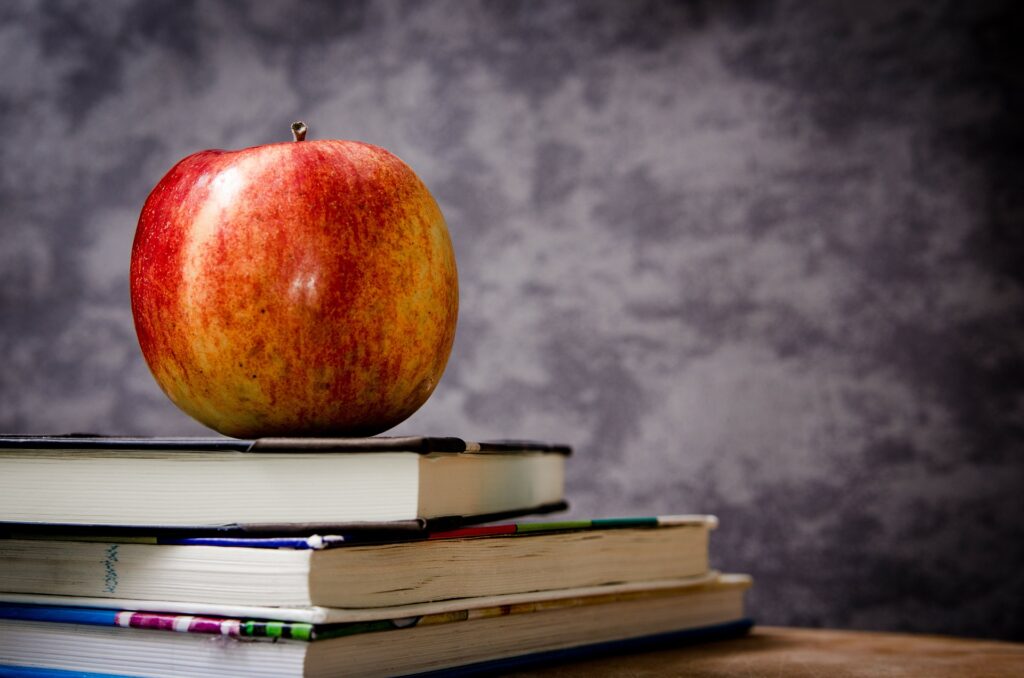 apple sitting on school books