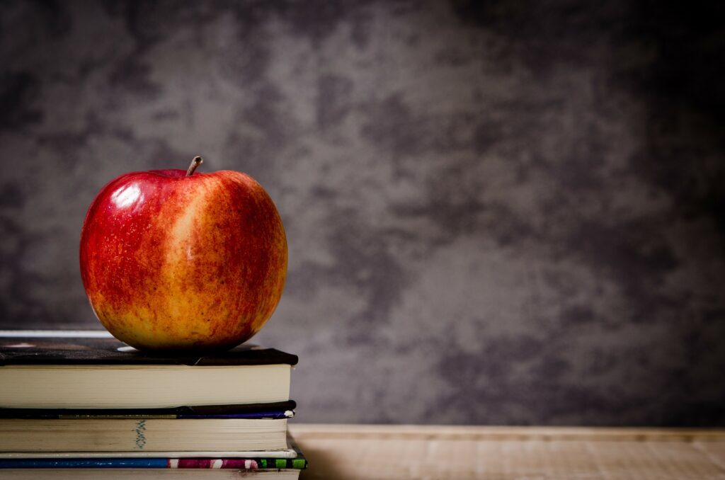 apple sitting on school books