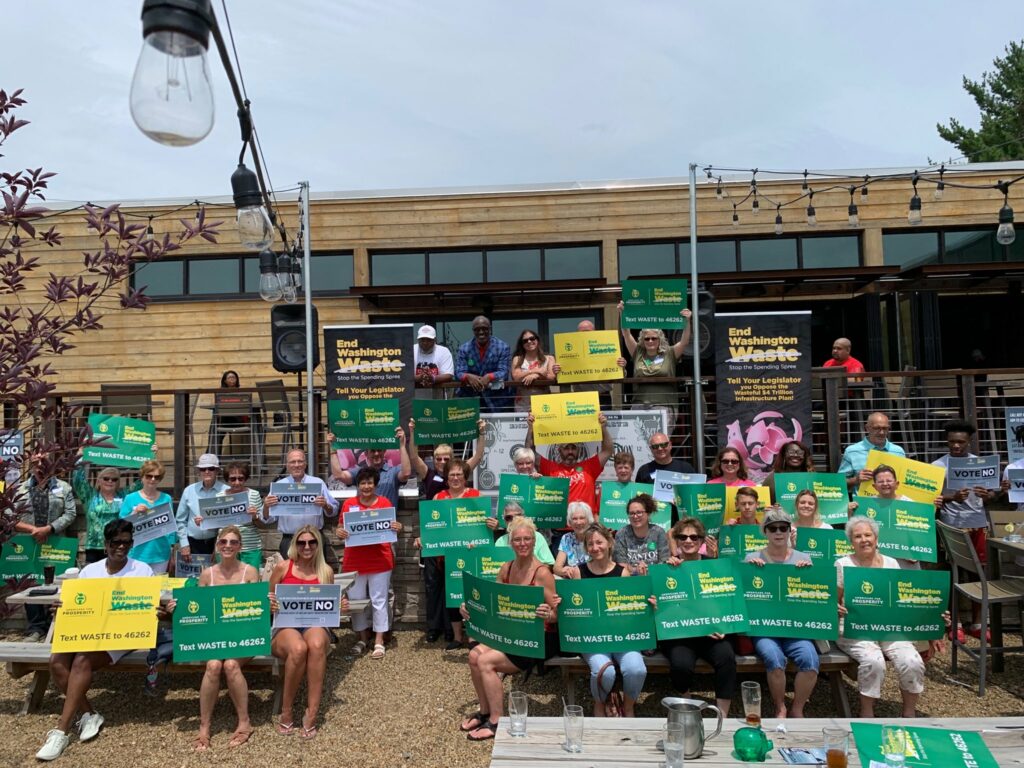 AFP activists display their "End Washington Waste" and "Stop the Spending Spree" signs at an infrastructure grassroots event