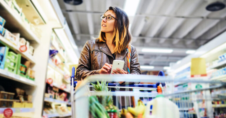 A woman grocery shopping is surprised by rising grocery prices