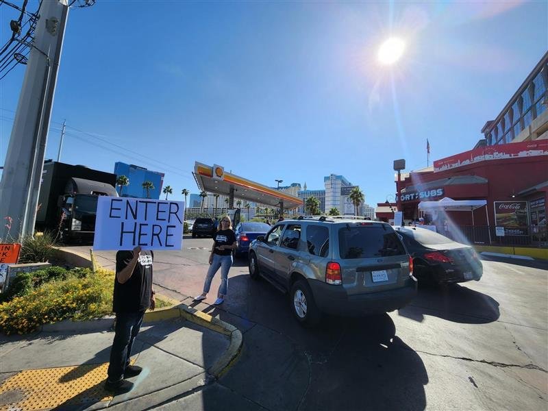 AFP-Nevada activists direct traffic at the True Cost of Washington gas station event in Las Vegas. The purpose of the event was to lower the cost of gas for customers to educate them about how Washington's reckless government spending is driving up gas prices. 