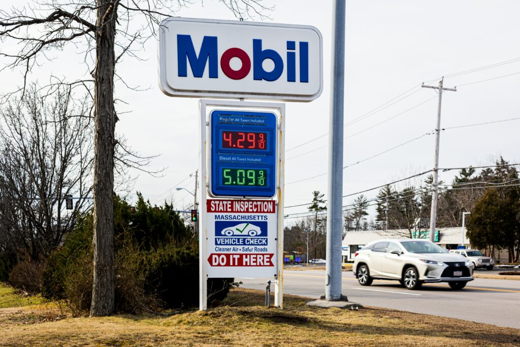Mobile gas station sign advertising high gas prices. Why is inflation increasing and driving up the cost of gas and groceries? Find out in this 60-second video.
