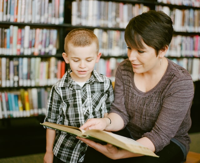 Governor Stitt's executive order bringing Oklahoma into compliance with the Supreme Court's ruling in Janus v. AFSCME strengthens the rights of Oklahoma educators. Here, a teacher reads with a student in the school library.