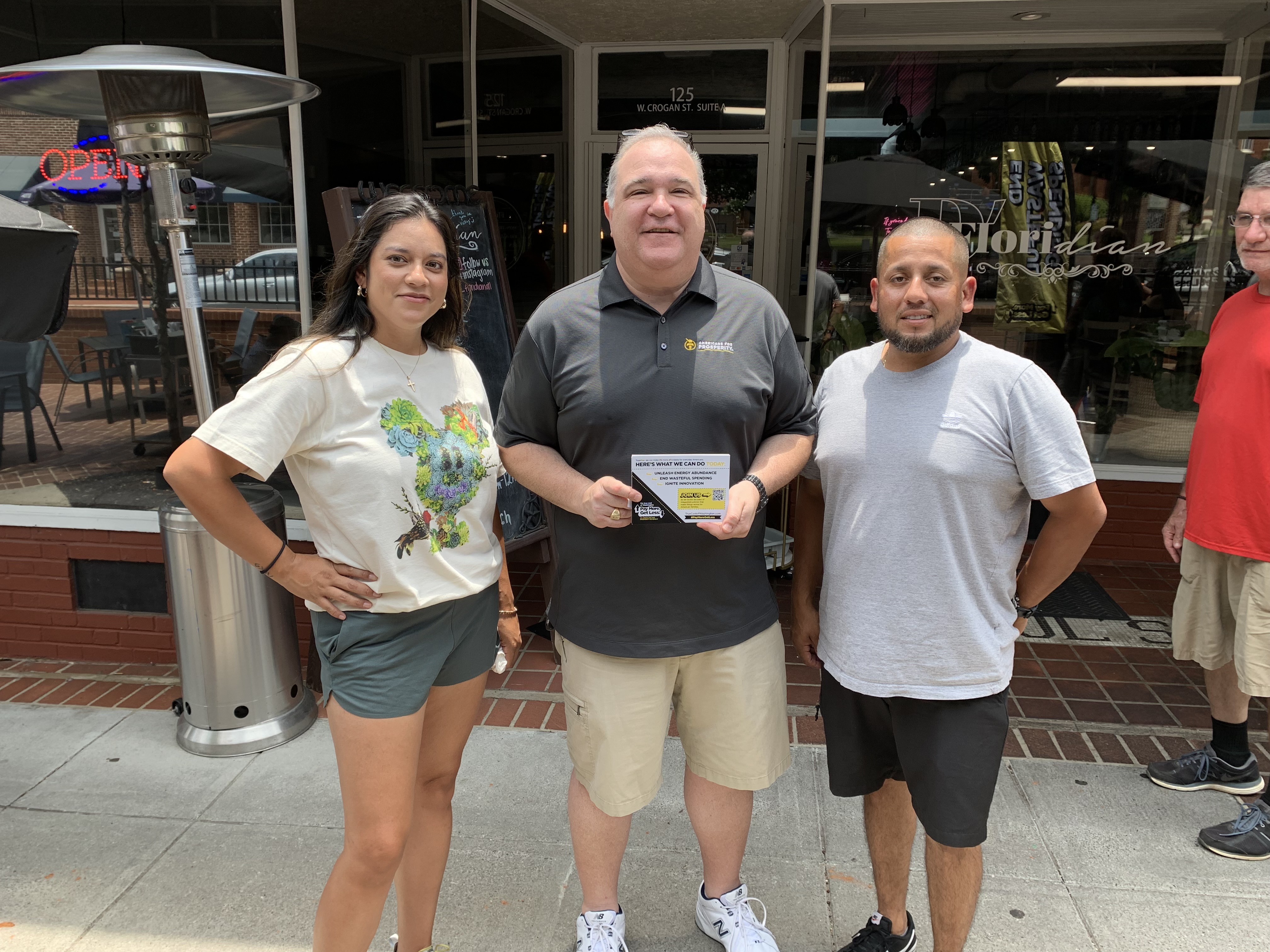 AFP staffer with customers at one of the True Cost of Washington Tour's many stops, where staffers heard from everyday Americans about how inflation was affection their families.