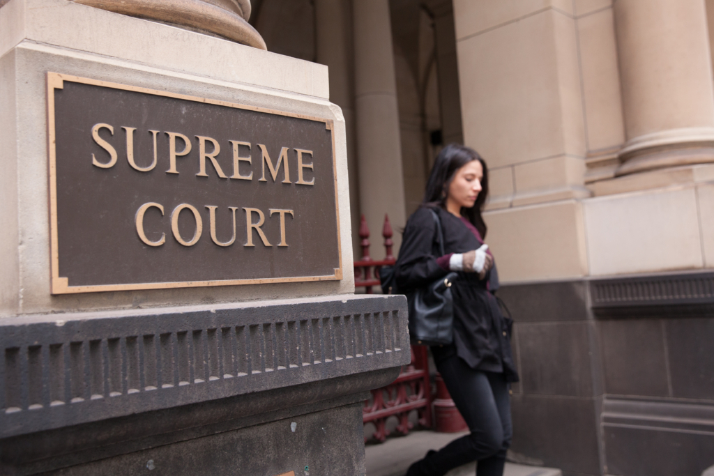 Person standing in front of Supreme Court building.