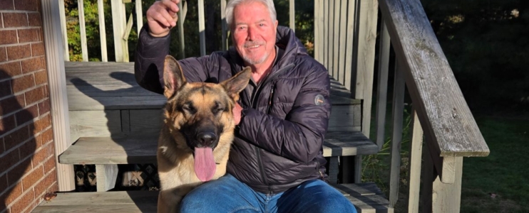 Toni Corsi sits on steps with dog