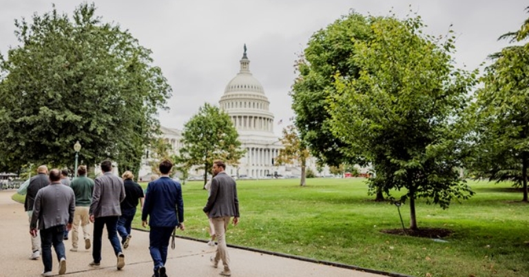 Alt text: Group of people walking toward the U.S. Capitol building in Washington, D.C..