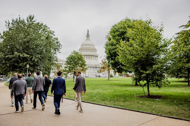 Alt text: Group of people walking toward the U.S. Capitol building in Washington, D.C..